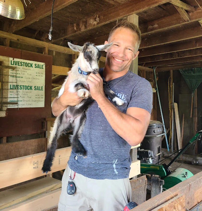 Who we are Photo with a baby goat